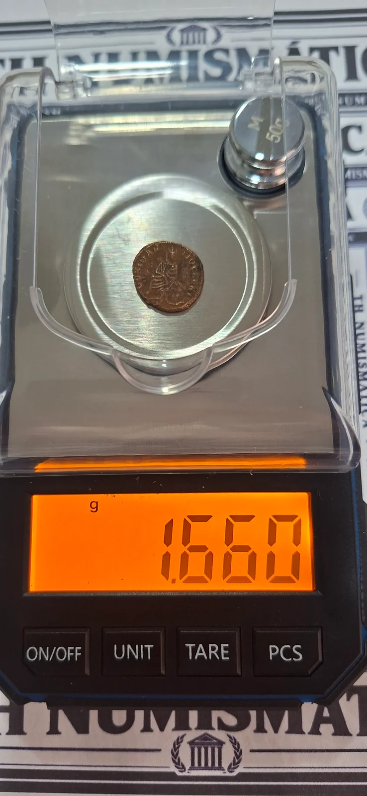 Peso (balança) da moeda TH-N-0228 — Maximino II. Fração AE, emissão de perseguição